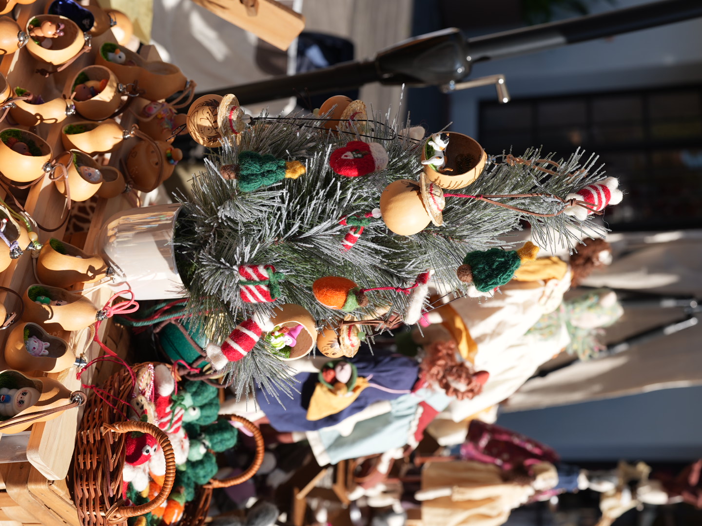 Mini gourds and felt ornaments hanging on a small tree