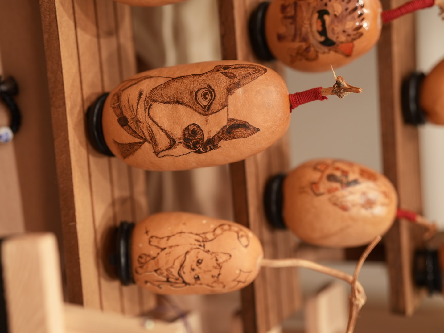 Close-up of gourd pyrography featuring animals